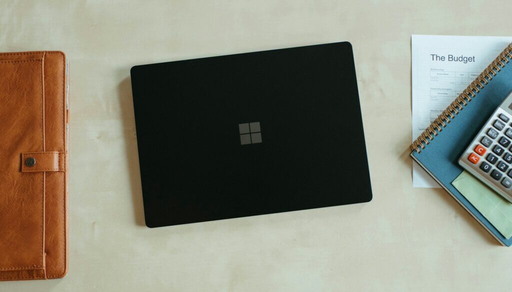 Website cost in Perth concept with a laptop and calculator on a desk